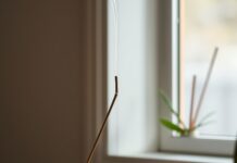 Burning Incense Indoors: What Smoke Means for Your Air Incense and asthma: a smoking incense stick near an open window, with smoke drifting outdoors.