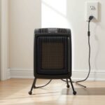 How to Use a Portable Space Heater More Safely Portable heater on a clear, level surface beside a wall outlet; power strip for space heater use is not recommended.